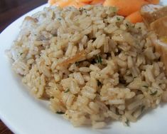 a plate with rice, carrots and other food items on top of the plate