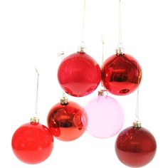 red and pink christmas ornaments hanging from strings