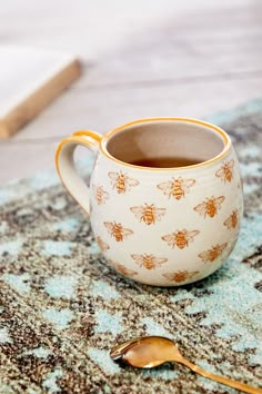 a cup of tea on a table with spoons