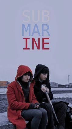 two people sitting on a bench with the words sub mar line in red, white and blue