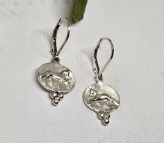 Fresh new design for 2024, our Fancy Horse Trot lever back earrings.  It is so difficult to find accurate horse poses and then a matching right and left earring!   These earrings have an added triple bead drop on the bottom of the oval, cast all as 1 piece of metal, adding an unusual elegance to the design.  The raised sculpted horse is quite small here. The overall earring measures just 5/8 inches tall x 9/16 inches wide and 1.25 inches tall overall with the lever back. The horse is a high polish and the background a satin, finished to a frosty look with a diamond bur.  Available in all sterling silver, OR our rose bronze on a gold vermeil/ sterling silver lever back. This design is part of a entire series, from a Buckle to pendants, earrings in 2 shapes, and more on our main online store Horse Jewelry Earrings, Horse Poses, Horse Earrings, Equestrian Jewelry, Horse Jewelry, Sterling Earrings, Gold Vermeil, Equestrian, Jewelry Earrings Dangle