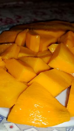 sliced up mangos on a plate ready to be eaten