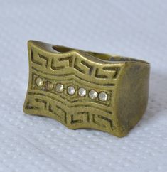 Vintage Moroccan Bronze Ring | Handmade Engraved Berber Jewelry Unique Berber Embrace the allure of Morocco with this exquisite vintage bronze ring. Handcrafted by skilled Berber artisans, this unique piece showcases the rich heritage and artistry of North Africa. Meticulously engraved with intricate patterns, the ring exudes a bohemian charm that effortlessly complements any style. The warm tones of the bronze metal lend a timeless elegance, making it a versatile accessory for both casual and s Vintage Gold Metal Rings, Vintage Ceremonial Jewelry Metal Ring, Vintage Ceremonial Metal Ring Jewelry, Antique Bronze Metal Rings, Vintage Adjustable Engraved Ceremonial Ring, Gold Brass Rings With Antique Finish, Antique Finish Bronze Jewelry For Anniversary, Antique Bronze Jewelry For Anniversary, Bronze Jewelry With Antique Finish For Anniversary