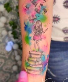 a girl is standing on top of a stack of books and holding a book in her hand