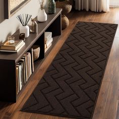 a brown rug is on the floor in front of a book shelf and bookshelf