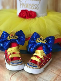 a pair of red, yellow and blue shoes with bows