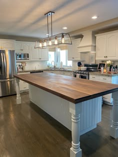 a large kitchen with an island in the middle