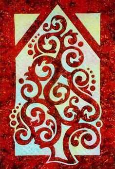 a red and white quilt with a christmas tree on the front, surrounded by swirls