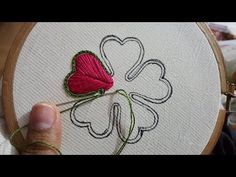 someone is stitching a four leaf clover on a hoop