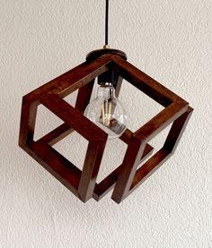 a wooden light fixture hanging from the ceiling