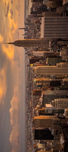 an aerial view of new york city with clouds in the sky and skyscrapers on either side