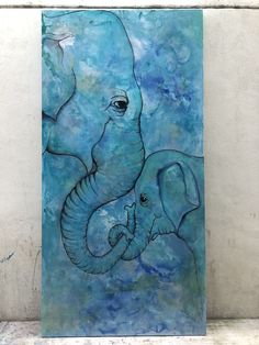 an elephant and its baby are depicted in this blue painting on a white brick wall