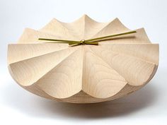 a clock made out of wood on a white surface