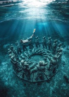 the underwater sculpture is surrounded by people