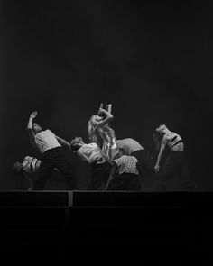 the dancers are performing on stage in black and white