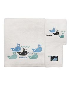 two white towels with blue whales on them