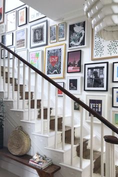 there is a staircase with pictures on the wall