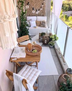 an outdoor patio area with wicker furniture and plants on the wall, along with white curtains