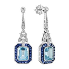 A pair of emerald cut blue topaz stones, precisely matched by eye, totaling 5.90 carats, and set into a pair of exquisite drop ear studs. These exquisite earrings are complimented by 3.78 carats of French cut blue sapphire and round diamonds finished into 14k white gold. Earrings Information Metal: 14K White Gold Width: 12 mm. Length: 39 mm. Weight: 8.50 g. (approx. in total) Backing: Push Back Center Gemstones Type: Blue Topaz Shape: Emerald Cut Size: 9x7 mm. Number: 2 Weight: 5.90 Carat (appro French Cut, Blue Topaz Stone, Estilo Art Deco, Topaz Stone, Gems Jewelry, Art Deco Jewelry, Exquisite Jewelry, Sapphire Diamond, Art Deco Style