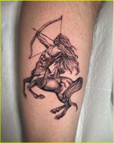 a man with a bow and arrow on his arm is riding a horse while holding an arrow