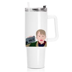 a white travel mug with an image of a man holding a camera on the side