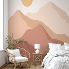 a bedroom with a mountain mural on the wall and a chair in front of it