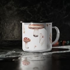 a coffee cup with mushrooms painted on it