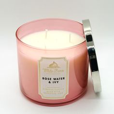 a pink candle sitting next to a metal container