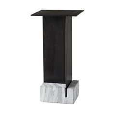 a black and white pedestal with a marble block on the bottom, in front of a white background