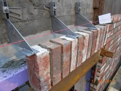 some bricks are lined up on a table and ready to be put into the oven