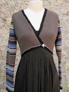 a mannequin wearing a dress and sweater on display