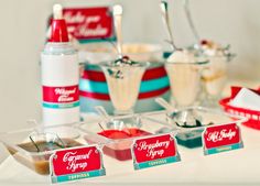 an assortment of condiments are displayed on a table with red and white striped napkins