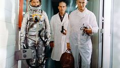 three men in space suits standing next to each other