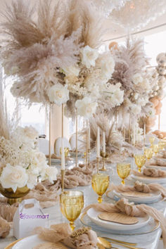 the table is set with white and gold decorations