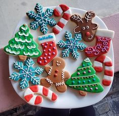 a white plate topped with lots of decorated cookies