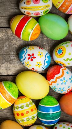 colorful painted easter eggs laid out on a wooden surface