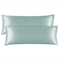 two light blue pillows sitting next to each other