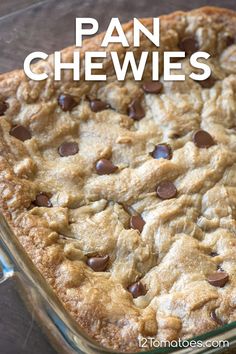 a close up of a pan of food with chocolate chip cookies on top and text overlay that reads, pan chewies