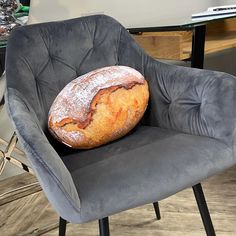 a loaf of bread sitting on top of a gray chair