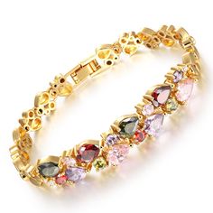 a gold bracelet with multi colored stones