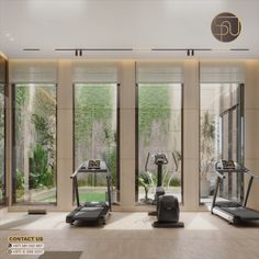 there are many treadmills in the room with glass doors that look out onto the garden