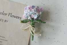 there is a small flower on top of a piece of paper that says color flowers comes by