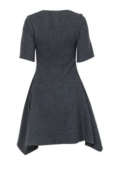 Go cool and classic for the office during those chilly months with this Stella McCartney frock! Made of 100% warm wool with a chic scarf hem in a classic fit and flare silhouette, this simple and sleek beauty is perfect for pairing with all your favorite professional pieces when the weather starts to cool down. Style with polished pumps and your favorite blazer for one bold boss lady ensemble! Size 6 (IT 42) Shell: 100% Wool Lining: 50% Cotton, 50% Rayon Concealed back zipper Lined Fit and flare Classic Wool A-line Dress, Fall A-line Midi Dress With Pleated Hem, Chic Dresses With Flared Hem For Fall, Chic Fall Dresses With Flared Hem, Chic Flared Hem Dresses For Fall, Formal Wool Dresses For Fall, Wool Dress For Formal Fall Events, Wool Dresses For Formal Fall Occasions, Classic Fall Dresses With Pleated Hem