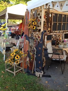 an outdoor market with sunflowers and other items