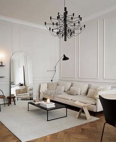 a living room filled with furniture and a chandelier