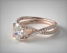 an engagement ring with a twisted band and a cushion cut diamond