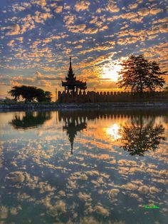 the sky is reflected in the water at sunset