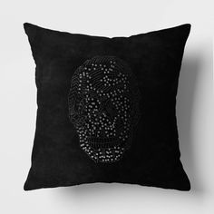 a black pillow with a white skull on it