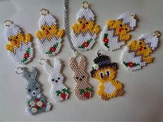 cross stitch keychains with different designs and animals on them, all made out of beads