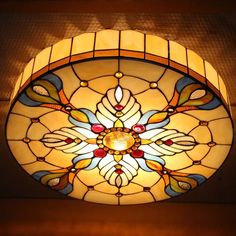 a stained glass ceiling light hanging from the ceiling